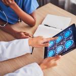 Doctor discussing an brain x-ray to a client.