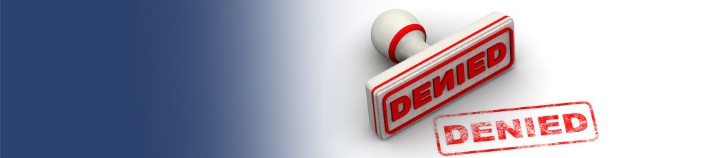 Denied stamp on documents representing a rejected insurance claim after a car accident in Texas