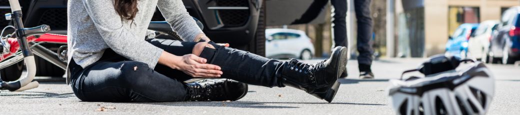 Injured pedestrian sitting on the road after being hit by a car in Edinburg near the UTRGV campus