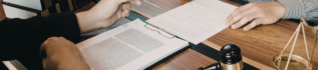 Lawyer reviewing insurance claim documents with a client after a car accident in McAllen, Texas