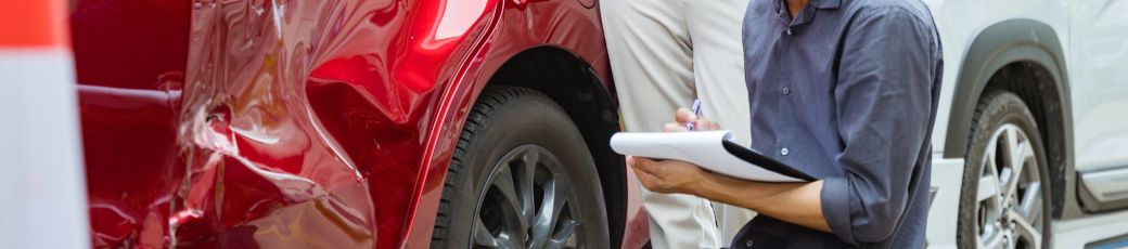 Person documenting vehicle damage after a car accident in Texas for a personal injury claim