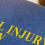 Personal injury law book and gavel representing a personal injury lawsuit in Texas