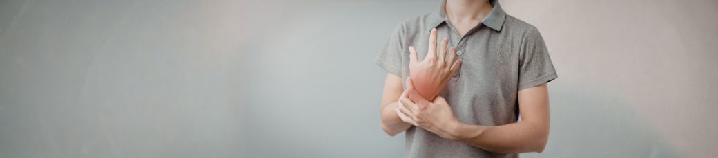 Person holding their wrist in pain representing injury and physical suffering after an accident in Texas