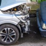 Two vehicles involved in a collision showing front-end damage, representing a partially at-fault accident in Texas