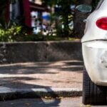 Damaged parked car after a hit-and-run accident in Texas parking area