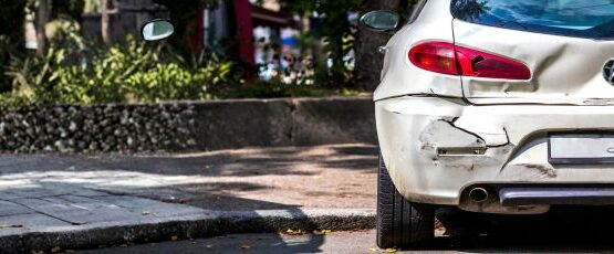 Damaged parked car after a hit-and-run accident in Texas parking area