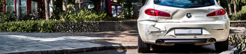 Damaged parked car after a hit-and-run accident in Texas parking area