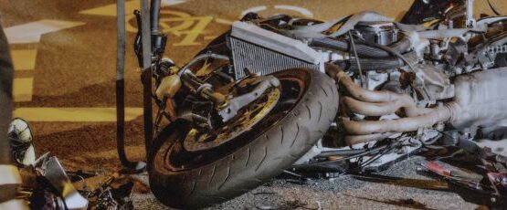 Motorcycle lying on the road after a crash with emergency response nearby in Texas