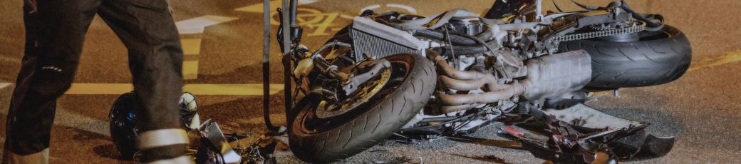 Motorcycle lying on the road after a crash with emergency response nearby in Texas