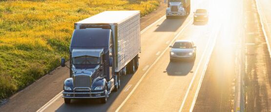 18-wheeler truck driving on a Texas highway alongside passenger vehicles