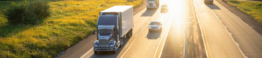 18-wheeler truck driving on a Texas highway alongside passenger vehicles