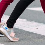 Students walking across a crosswalk near a university campus in Edinburg, Texas