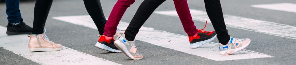Students walking across a crosswalk near a university campus in Edinburg, Texas