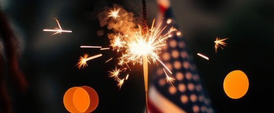 Person holding a lit sparkler during a Fourth of July celebration, highlighting Independence Day safety for families in McAllen and the Rio Grande Valley.