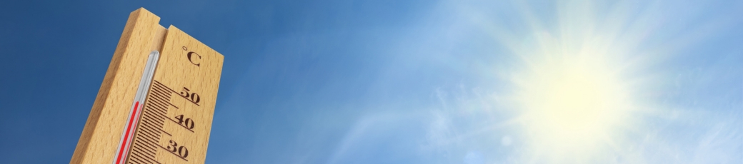 Thermometer showing high temperatures under a bright summer sun representing the risk of heat-related workplace injuries in McAllen and the Rio Grande Valley.