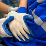 Injured worker holding their chest after an accident involving a potentially defective product