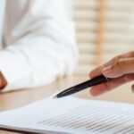 Attorney reviewing an insurance settlement offer with a car accident victim during a personal injury consultation in Texas.