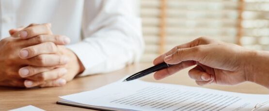 Attorney reviewing an insurance settlement offer with a car accident victim during a personal injury consultation in Texas.