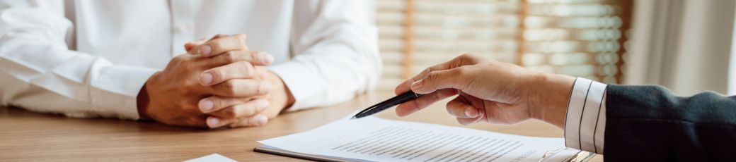 Attorney reviewing an insurance settlement offer with a car accident victim during a personal injury consultation in Texas.