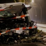 Severely damaged vehicle at a nighttime car accident scene