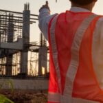 Construction workers wearing safety vests at a Texas construction site