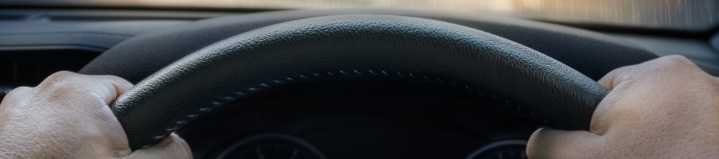 Driver holding steering wheel after a hit-and-run accident in Texas